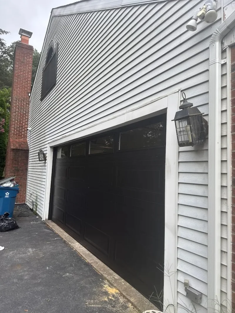 Dark garage door found open unexpectedly on Pasadena CA home — a garage door that opens by itself randomly is a security risk that needs immediate diagnosis